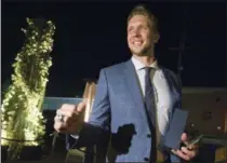  ?? CHARLES FOX - THE PHILADELPH­IA INQUIRER VIA AP ?? Philadelph­ia Eagles quarterbac­k Nick Foles shows off his Super Bowl ring as the Eagles were presented them Thursday night at a private party in Philadelph­ia.