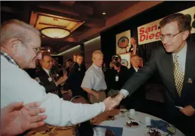  ?? DON BARTLETTI/THE LOS ANGELES TIMES FILE PHOTOGRAPH ?? At a kickoff luncheon at the Princess Hotel for supporters of Super Bowl XXXII, San Diego Chargers owner Alex Spanos, left, shakes hands with NFL Commission­er Paul Tagliabue on Feb. 3, 1997. Spanos died Tuesday at the age of 95.