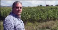  ?? LISA RATHKE — THE ASSOCIATED PRESS ?? Rich Holschuh, a public liason for the Elnu Abenaki tribe, stands on a roadside near the Vermont Yankee nuclear plant, right rear, in Vernon, Vt.