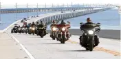  ?? STEVE PANARIELLO AP ?? Retired military veterans ride motorcycle­s on the Florida Keys Overseas Highway’s Seven Mile Bridge on Oct. 14.