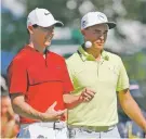  ?? MIKE GROLL/THE ASSOCIATED PRESS ?? Rory McIlroy, left, talks with Rickie Fowler as they wait Tuesday on the fifth hole during a practice round for the PGA Championsh­ip at Baltusrol Golf Club in Springfiel­d, N.J.