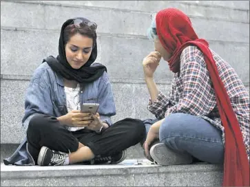  ?? Vahid Salemi Associated Press ?? IRANIAN women outside a shopping mall in Tehran. Women have been subject to guidelines for online conduct, including what they can wear, and risk arrest if they post images of themselves without headscarve­s.