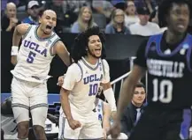  ?? ?? BAILEY, left, and point guard Tyger Campbell celebrate on the bench during the Bruins’ rout of North Carolina Asheville.