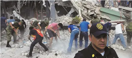  ?? AP PHOTO ?? GRIM DAY: Rescuers search in Mexico City yesterday after an earthquake struck on the same day as a 1985 temblor in the region that killed more than 5,000 people.