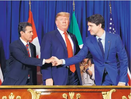  ?? ASSOCIATED PRESS ?? Then-President Enrique Peña Nieto of Mexico, U.S. President Donald Trump and Canadian Prime Minister Justin Trudeau signed the United States-Mexico-Canada Agreement on Nov. 30, 2018, in Buenos Aires, Argentina. The deal is still pending in the US Congress.