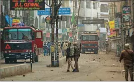  ??  ?? Police personnel guard a street after clashes between police and protestors against the Citizenshi­p Amendment Act (CAA) turned violent, in Kanpur