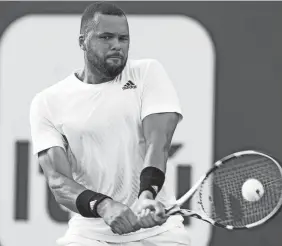  ?? MARTA LAVANDIER/AP ?? Jo-wilfried Tsonga hits a return to Jordan Thompson during a Miami Open match March 24 in Miami Gardens, Fla.