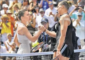  ?? USA TODAY SPORTS ?? ■ Simona Halep (left) congratula­tes Kaia Kanepi after losing 62, 64 on Day One of the US Open in New York on Monday.