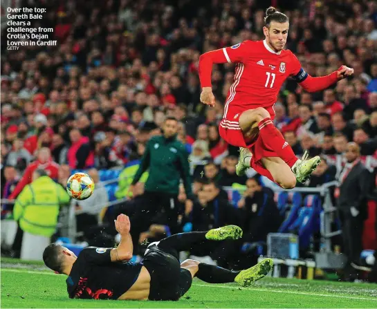  ?? GETTY ?? Over the top: Gareth Bale clears a challenge from Crotia’s Dejan Lovren in Cardiff