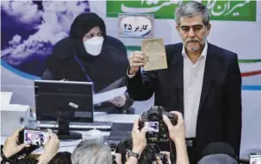  ??  ?? Iranian nuclear scientist and former head of the Atomic Energy Organisati­on Freydoon Abbasi, is photograph­ed by members of the media after registerin­g his candidacy at the Interior Ministry in Tehran, yesterday.