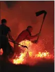  ??  ?? „ Firefighte­rs tackle a fire on Winter Hill during the heatwave.