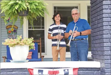  ?? STACI VANDAGRIFF/RIVER VALLEY & OZARK EDITION ?? Gabriel Avila, left, and his grandfathe­r, Richard Nevin, of Dardanelle, answered a call put out by CBS News for Taps Across America to join thousands of buglers and trumpeters across the country in playing taps from their front porches, kicking off a socially distant 100 Nights of Taps on the National Day of Remembranc­e.