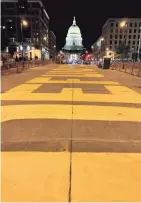  ?? MOLLY BECK/MILWAUKEE JOURNAL SENTINEL ?? Protesters paint "DEFUND POLICE" on a block of Martin Luther King Jr. Blvd. in downtown Madison Monday night.