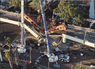  ?? Fernando Llano / Associated Press ?? An aerial view of subway cars dangling at an angle from a collapsed elevated section of the metro, in Mexico City on Tuesday.