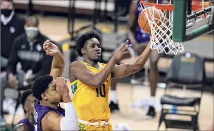  ?? Tony Gutierrez / Associated Press ?? Baylor guard Adam Flagler goes up for a shot over Stephen F. Austin forward Gavin Kensmil on Wednesday night.