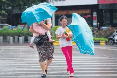  ?? Picture: AFP ?? DANGER. Strong winds batter people ahead of the arrival of typhoon Mangkhut in Yangjiang in China’s Guangdong province yesterday.