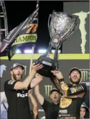  ?? TERRY RENNA - THE ASSOCIATED PRESS ?? Martin Truex Jr., right, and crew chief Cole Pearn celebrate in Victory Lane after winning the NASCAR Cup Series auto race and season championsh­ip at Homestead-Miami Speedway in Homestead, Fla., Sunday.