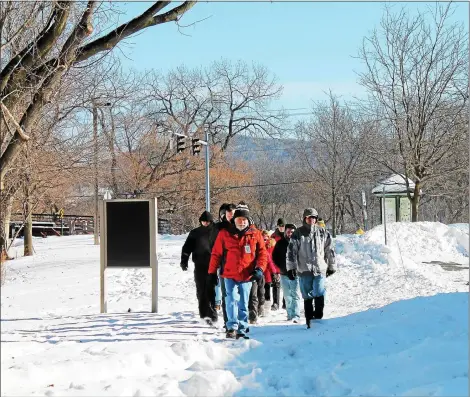  ?? MEDIANEWS GROUP FILE PHOTO - LAUREN HALLIGAN ?? A group of eventgoers take a New Year’s Day hike at Peebles Island State Park. This year more than 75location­s around the state are planning to host First Day Hikes.