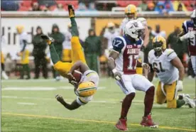  ?? GRAHAM HUGHES, THE CANADIAN PRESS ?? Edmonton Eskimos’ C.J. Gable dives in for a touchdown as Montreal Alouettes Brandon Stewart looks on during Monday’s game.
