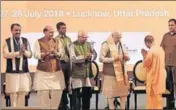  ?? SUBHANKAR CHAKRABORT­Y/HT ?? ■ Uttar Pradesh CM Yogi Adityanath greets PM Narendra Modi as Governor Ram Naik (centre) and Union home minister Rajnath Singh look on in Lucknow on Saturday.