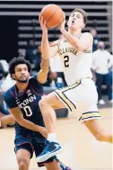  ?? MATT SLOCUM/AP ?? Villanova’s Collin Gillespie (2) goes up for a shot against UConn’s Jalen Gaffney (0) during the first half Saturday in Villanova, Pa. Gillespie was a pain all afternoon for the Huskies.