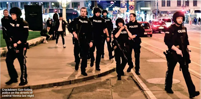  ??  ?? Crackdown: Gun-toting police on the streets of central Vienna last night