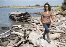  ?? Photos by Jessica Christian / The Chronicle ?? Amy Richey, with the San Francisco Estuary Institute, views a defensive shoreline on the Heron Bay Trail in Hayward.