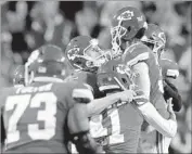  ?? Jamie Squire Getty Images ?? HARRISON BUTKER, center, is mobbed by Chiefs teammates after kicking a 43-yard field goal.