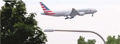  ?? TIM BOYLE FILE PHOTO/ FOR THE SUN- TIMES ?? An American Airlines plane prepares to land from the east beyond a street light at O’Hare Airport.