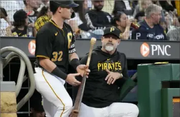  ?? Associated Press file photo ?? Pirates’ Derek Shelton, right, stands on the dugout steps as Henry Davis takes the field Sept. 30 against the Marlins at PNC Park.