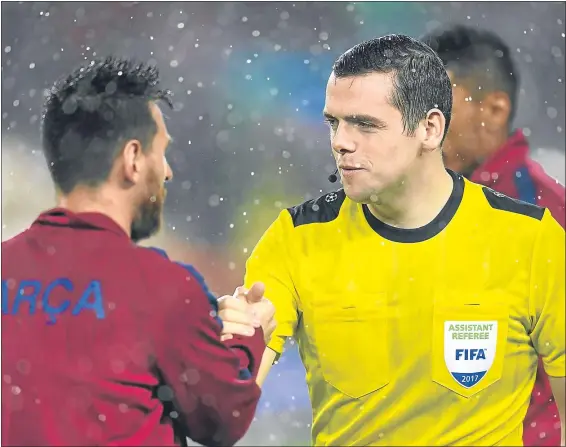  ??  ?? Assistant referee Douglas Ross shakes hands with Lionel Messi after the Champions League match between Barcelona and Olympiakos Piraeus