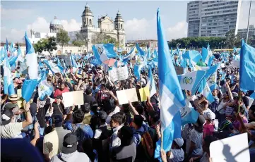  ??  ?? Demonstrat­ors protest against Morales in front of the National Palace in Guatemala City. — Reuters photo