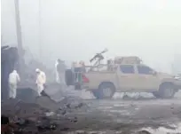  ?? Associated Press ?? Security forces inspect the site of a suicide bomb attack in Kabul on Thursday.