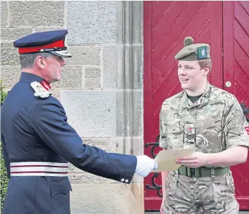  ??  ?? BIG DAY: Lord-lieutenant Stephen Leckie presents the certificat­e to Lachlann Forsyth.