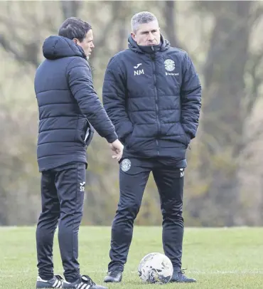  ?? ?? Hibs boss Nick Montgomery and assistant Sergio Raimundo at training ahead of facing Ross County