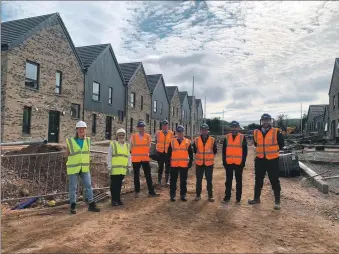  ?? ?? The council party visit the new council houses in Brathwic Terrace.