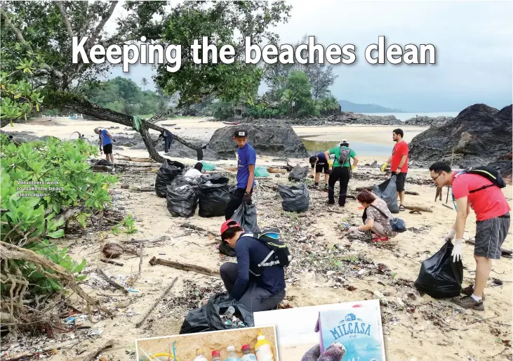  ??  ?? Volunteers work to make the beach clean again.