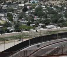  ?? AP PHOTO/CEDAR ATTANASIO ?? In this April 22, 2020, file photo a residentia­l neighborho­od of Juarez, Mexico, and U.S. Border Patrol vehicles on both sides of a border fence as seen from El Paso Texas. The Border Patrol’s parent agency said Friday that it fired four employees and suspended 38 were without pay for inappropri­ate social media activity following revelation­s of a secret Facebook group that mocked members of Congress and migrants.