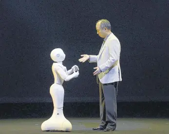  ?? EPA ?? Electric dreams: SoftBank CEO Masayoshi Son interacts with humanoid robot ‘Pepper’