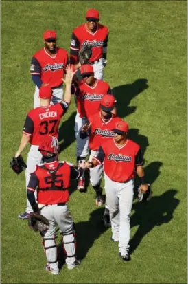  ?? CHARLIE RIEDEL — ASSOCIATED PRESS ?? Indians players celebrate after beating the Royals on Aug. 26 in Kansas City, Mo.