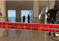  ?? (Israel Police) ?? POLICE EXAMINE the entrance to the murder suspect’s apartment in Tiberias yesterday.