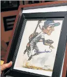  ??  ?? BUDDY BALL: Memorabili­a at Harrelson’s Hauppague home includes a photo of his fight with Pete Rose in the 1973 playoffs, which Rose signed to him along with a pair of boxing gloves, and a caricature by sports artist Bruce Stark.