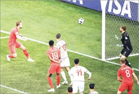  ?? AFP ?? England striker Harry Kane heads past Tunisia goalkeeper Farouk Ben Mustapha to score his side’s winner in their Group G match at the Russia 2018 World Cup in Volgograd on Monday night.