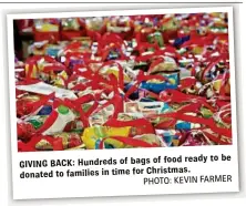  ??  ?? be food ready to GIVING BACK: Hundreds of bags of donated to families in time for Christmas.
PHOTO: KEVIN FARMER