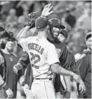  ?? LLOYD FOX/BALTIMORE SUN ?? Red Sox starter Rick Porcello gets teammates’ congratula­tions after his complete-game victory Monday night.