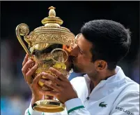  ?? AELTC/SIMON BRUTY/POOL/GETTY IMAGES ?? Novak Djokovic of Serbia celebrates with the trophy after winning his men's Singles Final match against Matteo Berrettini of Italy on Sunday in London.