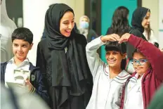  ?? ?? ■ Shamma Al Mazroui with students of determinat­ion at the ceremony in Abu Dhabi. The UCS programme is one of the most successful Special Olympics UAE’s initiative­s.