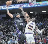  ?? Sara Nevis The Associated Press ?? Kings center Javale Mcgee goes to the basket against Lakers forward Lebron James in the first half of Sacramento’s 132-127 win Sunday at Golden 1 Center.