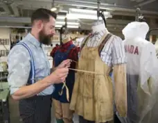  ?? ANNE-MARIE JACKSON PHOTOS/TORONTO STAR ?? Cutter/tailor Chris Read works on Geppetto’s costume.