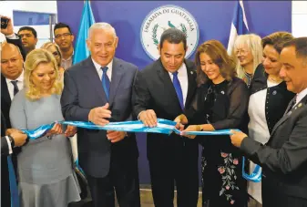  ?? Ronen Zvulun / AFP / Getty Images ?? Sara Netanyahu (left), her husband, Prime Minister Benjamin, Guatemala President Jimmy Morales and his wife, Hilda, help to dedicate Guatemala’s embassy.